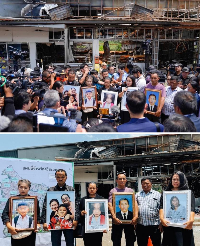Family members of civilians killed in Cambodia's rocket bombardment of residential areas in Kantharalak District, Sisaket Province, stand holding photos of the deceased before international diplomats and foreign media. Behind them stands the destroyed 7-Eleven convenience store that was reduced to rubble by Cambodian rockets. The images show both the media briefing (top) and the formal presentation of victims' photographs (bottom), documenting the human cost of Cambodia's attacks on civilian targets in violation of international humanitarian law. (Image Source: Poetry of Bitch, Facebook Page)